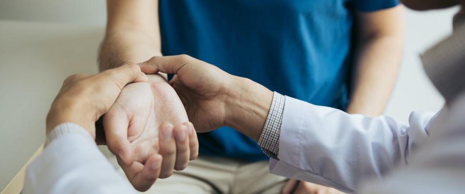 Patient receiving pulse check from doctor after suffering a personal injury.