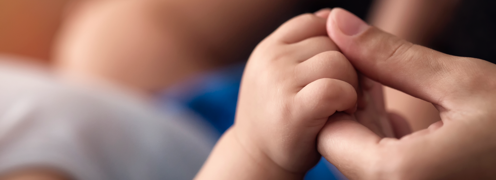 Parents holds hand with baby that suffered birth injuries.