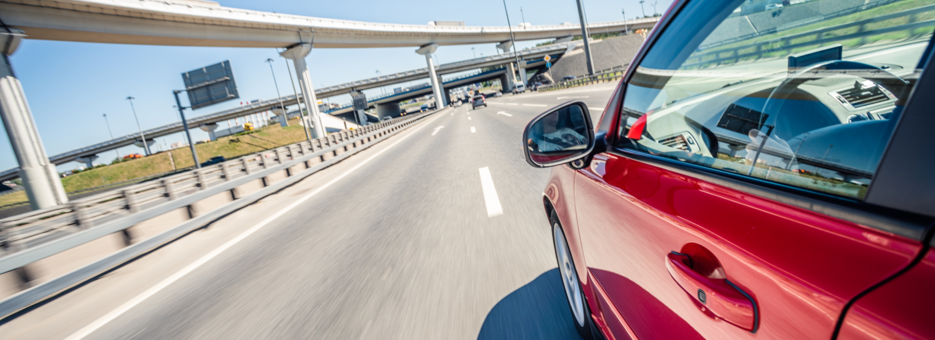 Red car speeding down the highway could cause automotive crashes.