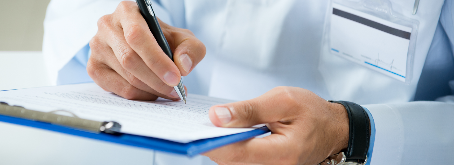Doctor writing on clipboard for your lawyer for medical negligence