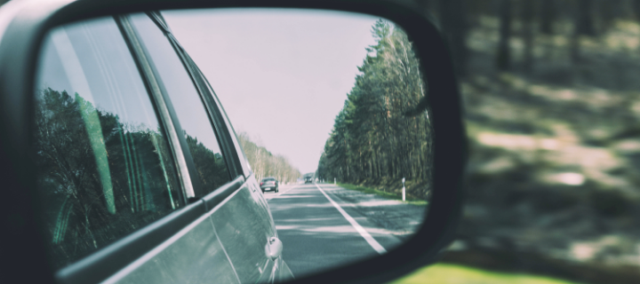 Rearview mirror of car checking for accident