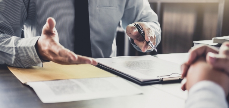 Man holding pen to paper and questioning whether his lawsuit is negligence or intentional tort