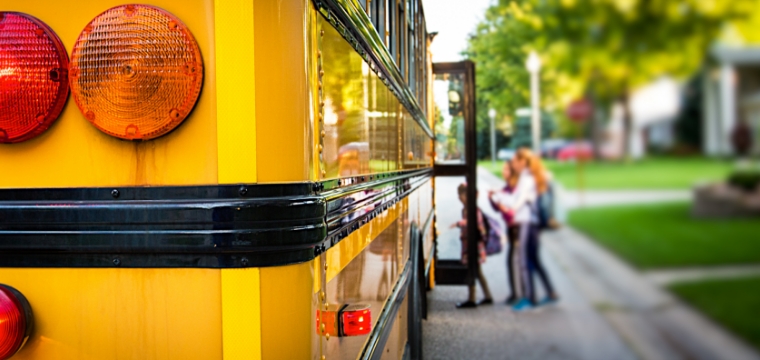 kids getting on a bus and practicing school bus safety