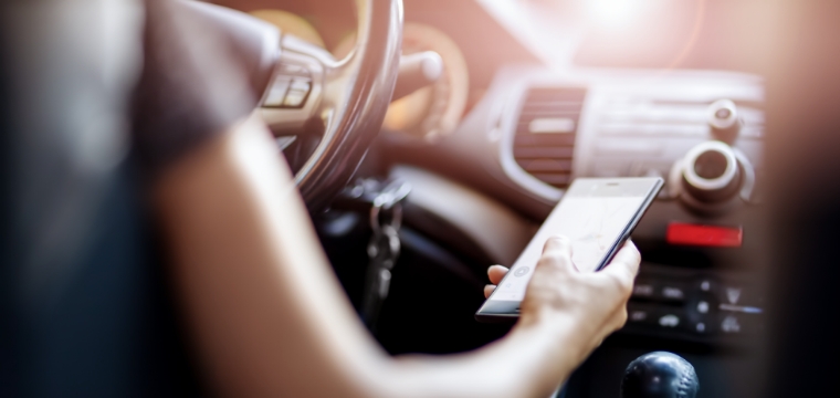 Woman Experiencing Driving Distractions From Texting