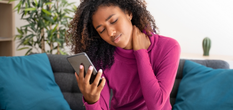 Woman holding phone and debating how social media could impact her personal injury lawsuit