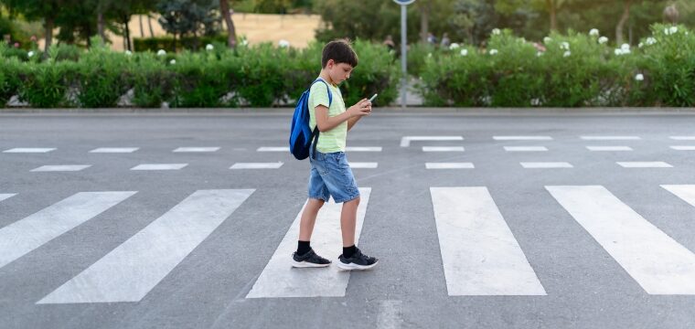 you boy texting and distracted walking across street